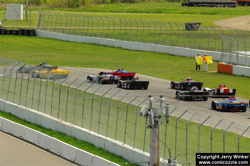 The Spec Racer Ford 3 field comes through turn 12 on the pace lap.