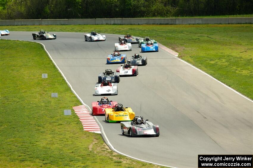 The Spec Racer Ford 3 field comes through turns 5 and 6 on lap one.