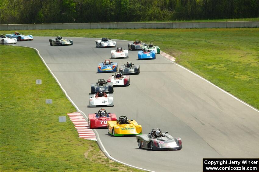 The Spec Racer Ford 3 field comes through turns 5 and 6 on lap one.