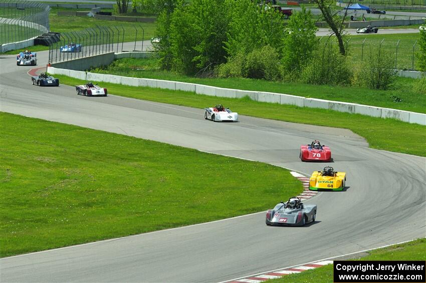 The first half of the Spec Racer Ford 3 field comes through turns 10 and 11.