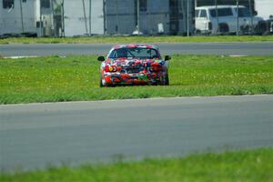 Chris Craft's Spec Miata Mazda Miata pulls off course at turn 6 on the pace lap.