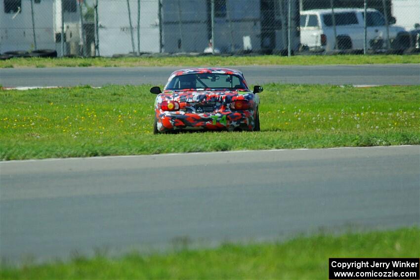 Chris Craft's Spec Miata Mazda Miata pulls off course at turn 6 on the pace lap.