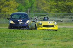 Brooke Fairbanks' H Production Triumph Spitfire and Andrew Janssen's B-Spec Honda Fit