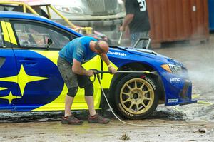 One of the Subaru WRX STis is power-washed before Sunday's competition.