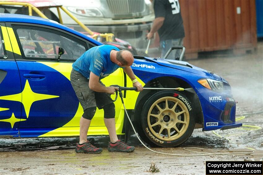 One of the Subaru WRX STis is power-washed before Sunday's competition.