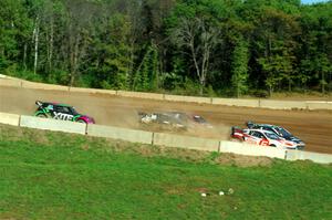 Five cars battle into the first turn during one of Sunday's heat races.