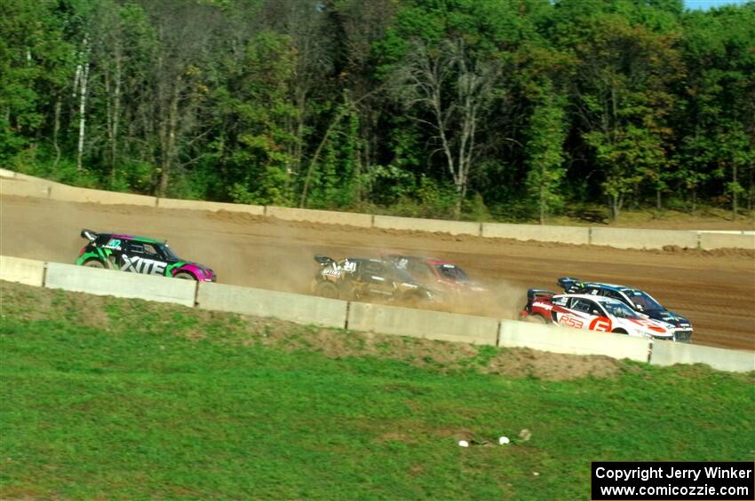 Five cars battle into the first turn during one of Sunday's heat races.