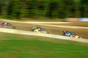 Five cars battle into the first turn during one of Sunday's heat races.