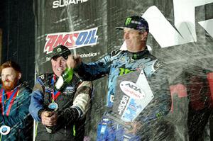 Paul Rowley and Ken Block spray champagne on the winners' podium.
