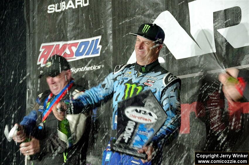 Paul Rowley and Ken Block spray champagne on the winners' podium.