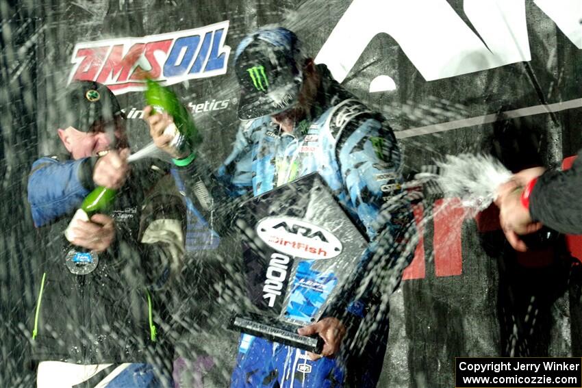 Paul Rowley and Ken Block spray each other on the winners' podium.