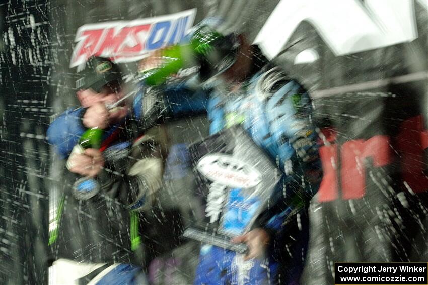 Paul Rowley and Ken Block spray each other on the winners' podium.