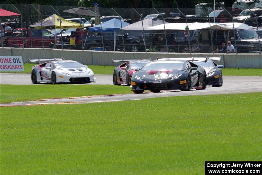 Brandon Gdovic / Todd Snyder Lamborghini Huracán LP 620-2 Super Trofeo leads a pack of cars.