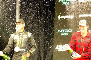 Travis Pastrana and Brian Deegan spray the crowd at victory lane.