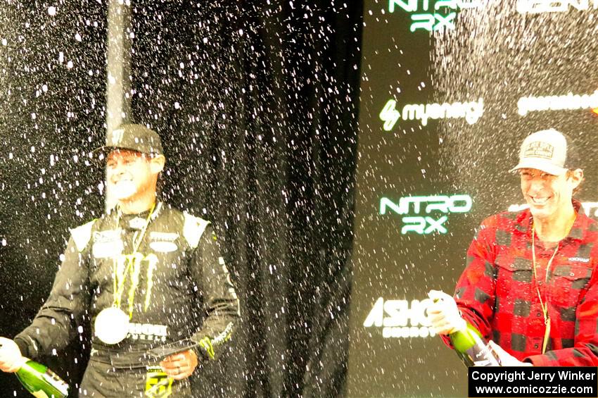 Travis Pastrana and Brian Deegan spray the crowd at victory lane.