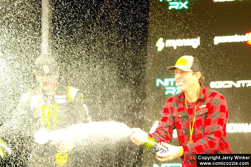 Travis Pastrana and Brian Deegan spray the crowd at victory lane.