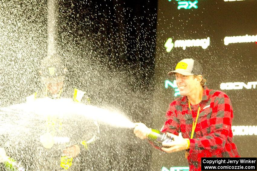 Travis Pastrana and Brian Deegan spray the crowd at victory lane.