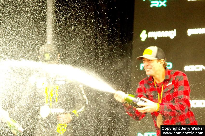 Travis Pastrana and Brian Deegan spray the crowd at victory lane.