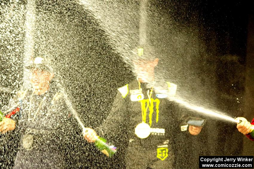 Travis Pastrana and Brian Deegan spray the crowd at victory lane.