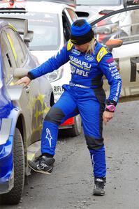 Rhianon Gelsomino checks for damage on the Subaru WRX STi she shared with Travis Pastrana prior to SS14, Trouble II.