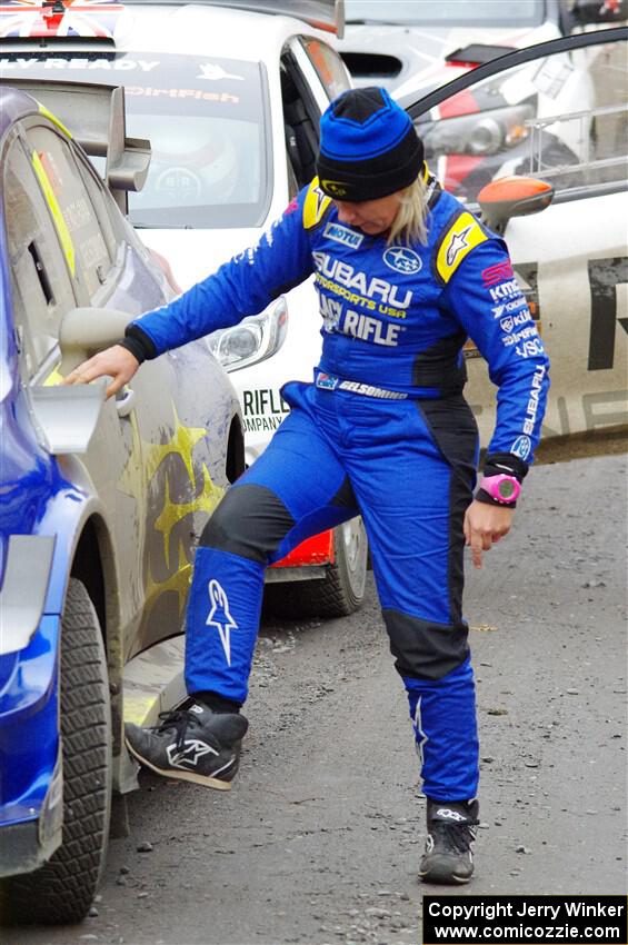 Rhianon Gelsomino checks for damage on the Subaru WRX STi she shared with Travis Pastrana prior to SS14, Trouble II.