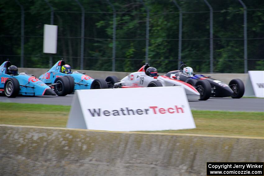 Four cars dice for third into turn 3.