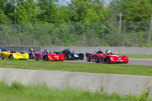 The Spec Racer Ford 3 field comes into turn 2.