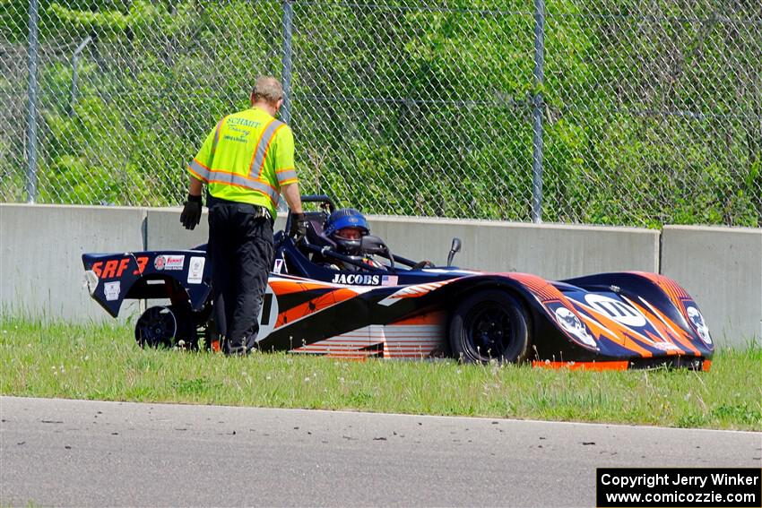 Ben Jacobs' Spec Racer Ford 3 rests against the wall as the safety team arrives.