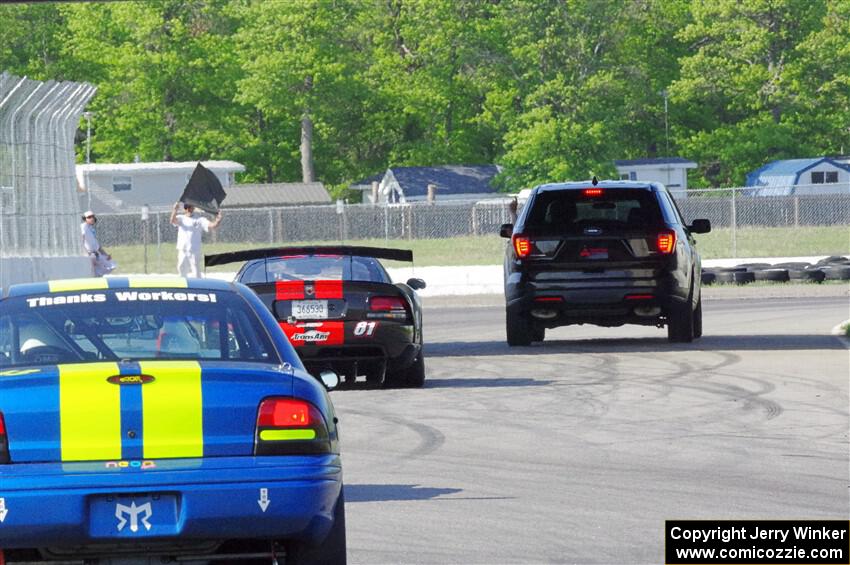 Keith Anderson's SPO Dodge Viper and John Glowaski's ITA Chrysler Neon ACR head for the track exit.