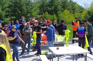 Workers get their vests after the meeting.