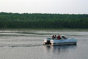 A group on a pontoon boat spectates SS6, Camp 3 South.