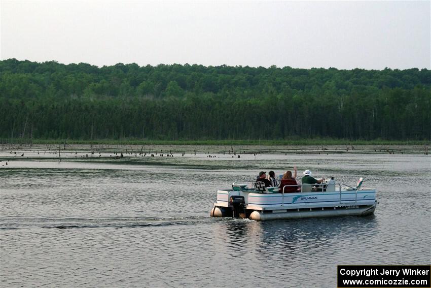 A group on a pontoon boat spectates SS6, Camp 3 South.