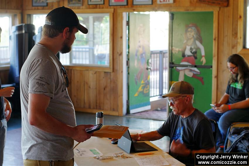 Eric Linner checks in workers at registration.