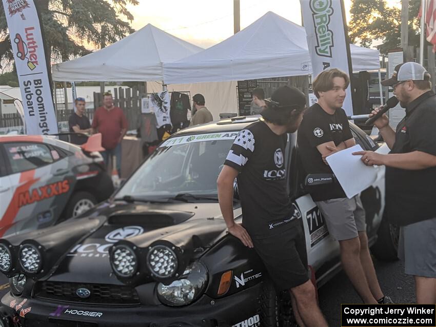 John Farrow and Michael Farrow are interviewed in front of their Subaru WRX at Thursday evening's parc expose.