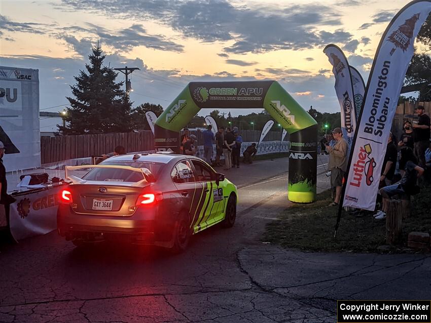 Tim Rooney / Mike Rossey Subaru WRX STi rolls up to the start line for Thursday night's ceremonial start.