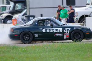 Sam Nogosek's Spec Miata Mazda Miata loses its engine after the finish line.