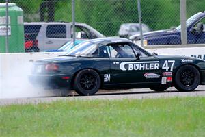 Sam Nogosek's Spec Miata Mazda Miata loses its engine after the finish line.