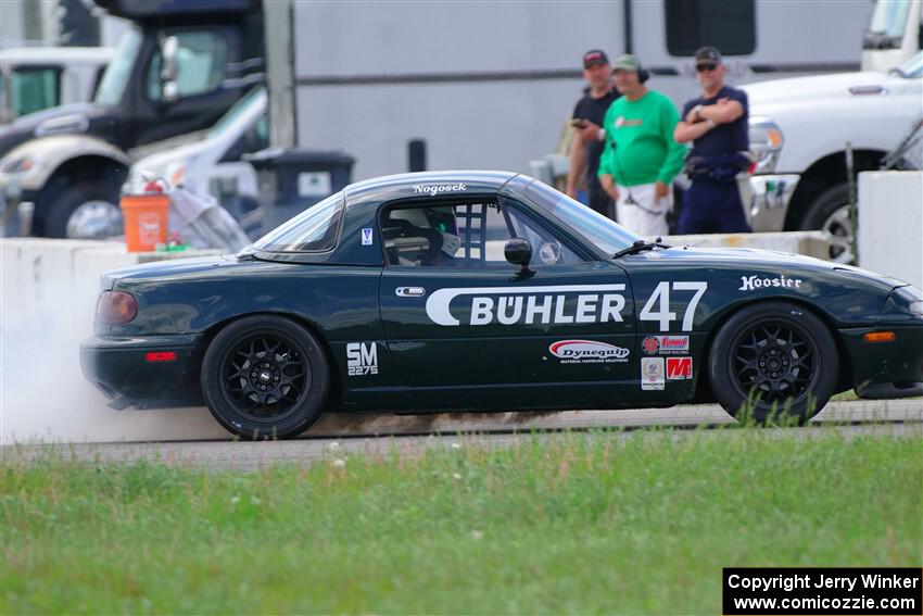 Sam Nogosek's Spec Miata Mazda Miata loses its engine after the finish line.