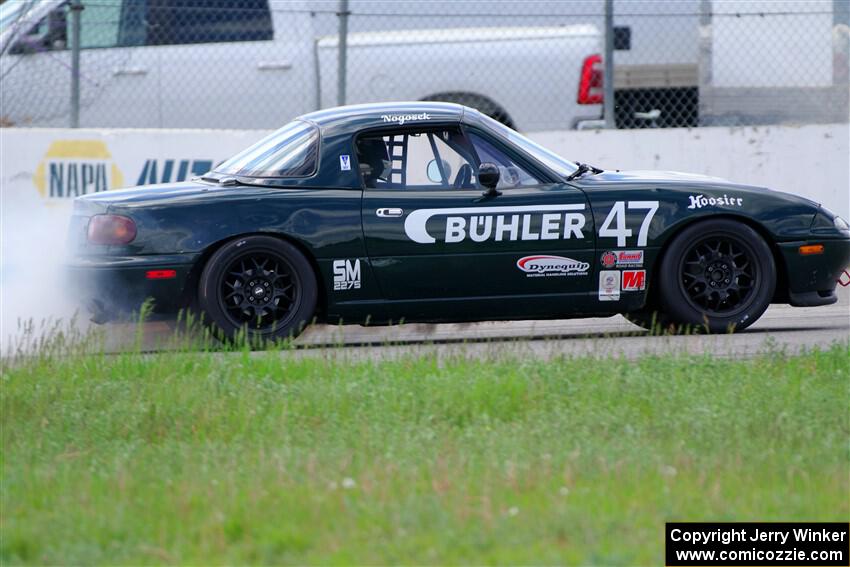 Sam Nogosek's Spec Miata Mazda Miata loses its engine after the finish line.