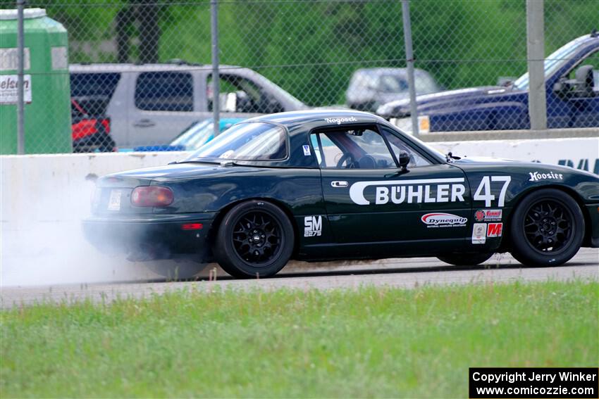 Sam Nogosek's Spec Miata Mazda Miata loses its engine after the finish line.