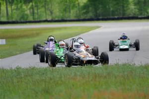 Five vintage Formula Fords come into turn 4.