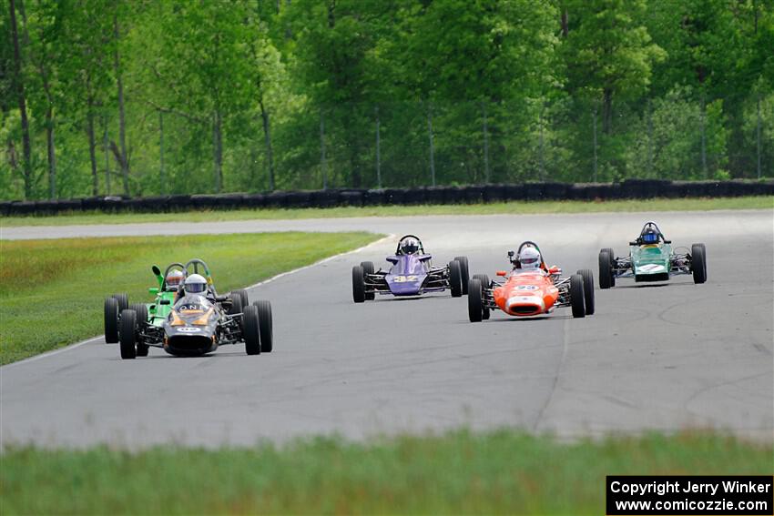 Five vintage Formula Fords come into turn 4.