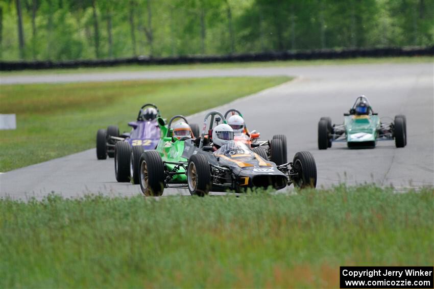 Five vintage Formula Fords come into turn 4.