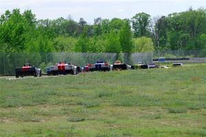 The Spec Racer Ford 3 field heads between turns 6 and 7 on the pace lap.