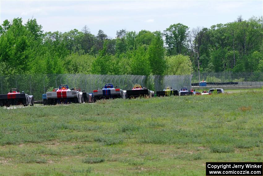 The Spec Racer Ford 3 field heads between turns 6 and 7 on the pace lap.