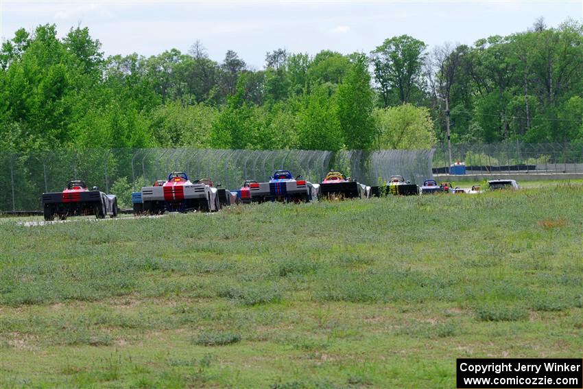 The Spec Racer Ford 3 field heads between turns 6 and 7 on the pace lap.