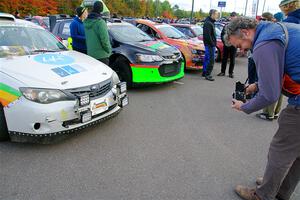 A photographer takes a picture of the Sam Jacques / Trevor LaCombe Subaru Impreza with his vintage camera.