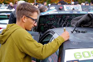 A fan adds his signature to the Keenan Phillips / Salina Melotti BMW 328i.