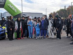 Women drivers and navigators gather for a group shot before the ceremonial start.