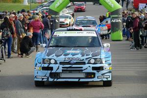 Lia Block / Rhianon Gelsomino Ford Escort Cosworth RS leaves the ceremonial start.